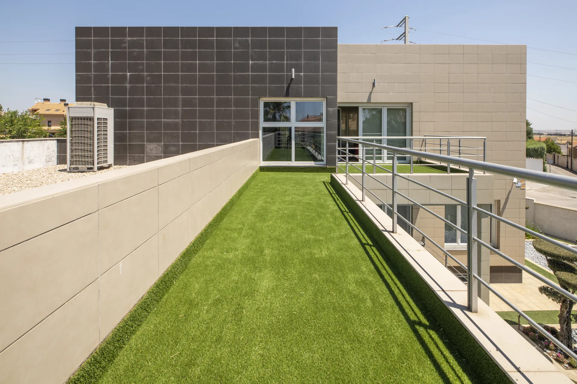 A landscaped Australian backyard with freshly laid artificial turf